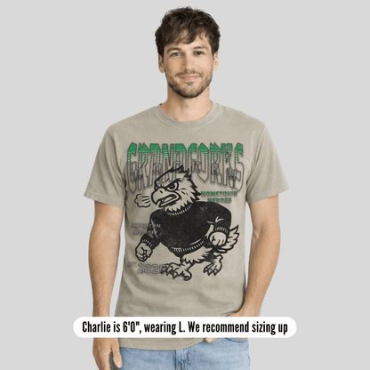 Man wearing a t-shirt with a graphic design on a plain background