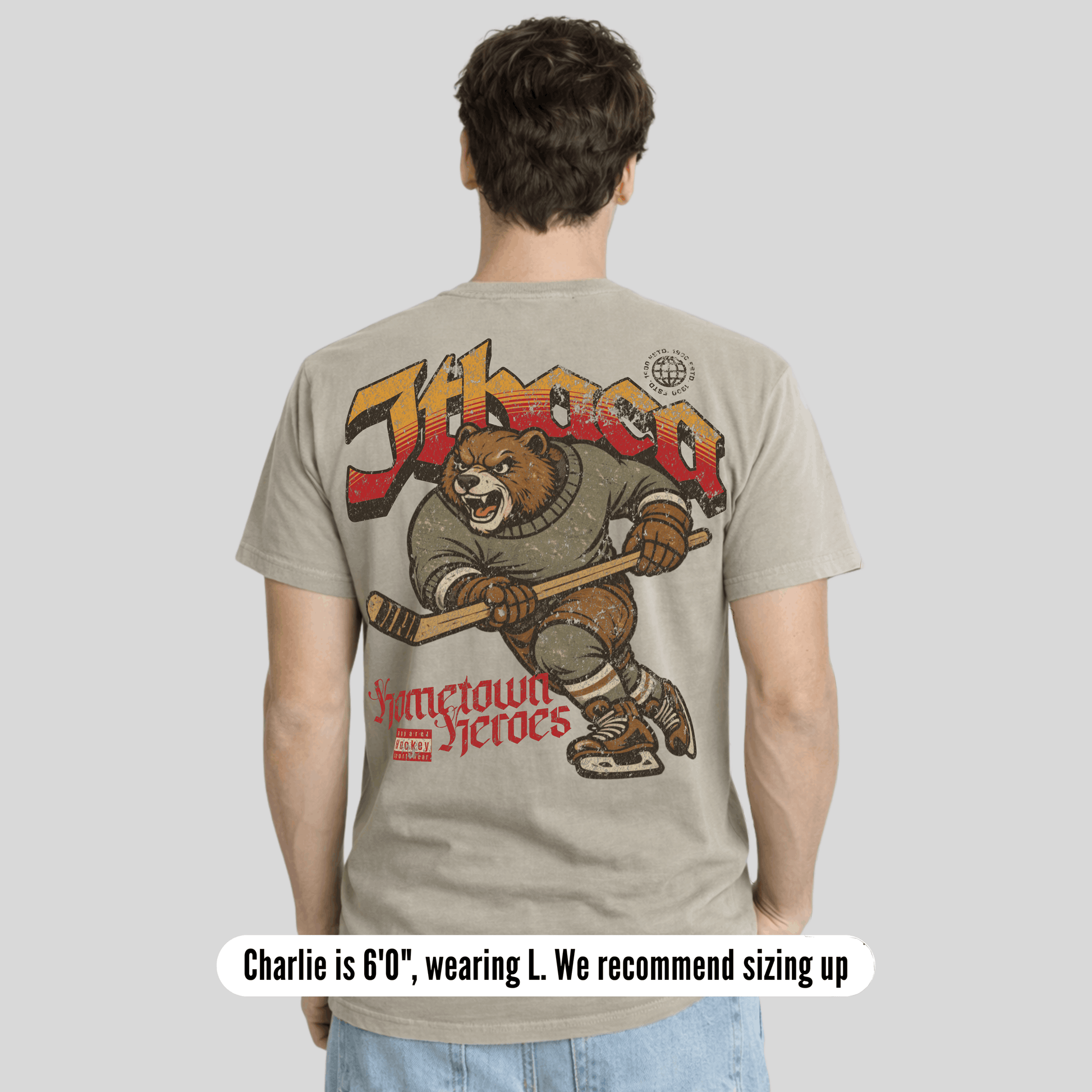 Person wearing a t-shirt with a bear graphic and text on the back, on a plain background.