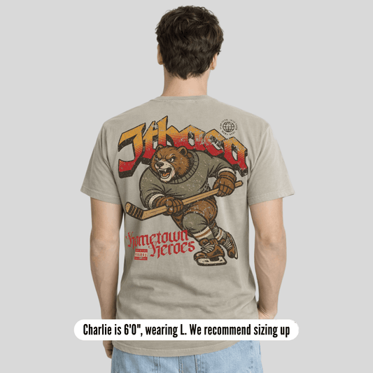 Person wearing a t-shirt with a bear graphic and text on the back, on a plain background.
